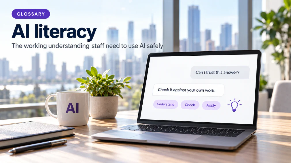 A laptop on a sunlit wooden office desk showing a chat interface where the request "Can I trust this answer?" is answered with "Check it against your own work." above three violet chips reading Understand, Check and Apply beside a small violet lightbulb icon, next to a mug printed with AI, a plant, a notebook and a pen, under a GLOSSARY badge, the heading AI literacy and the subtitle The working understanding staff need to use AI safely.